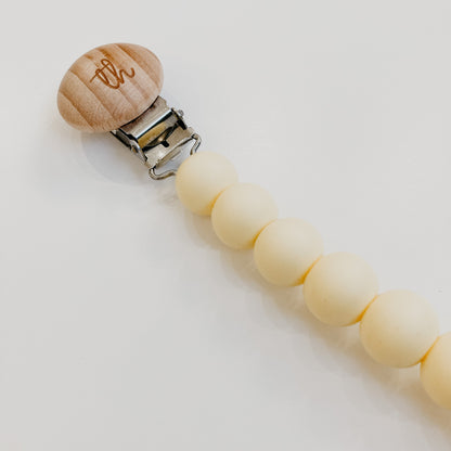 the butter yellow pacifier clip close up
