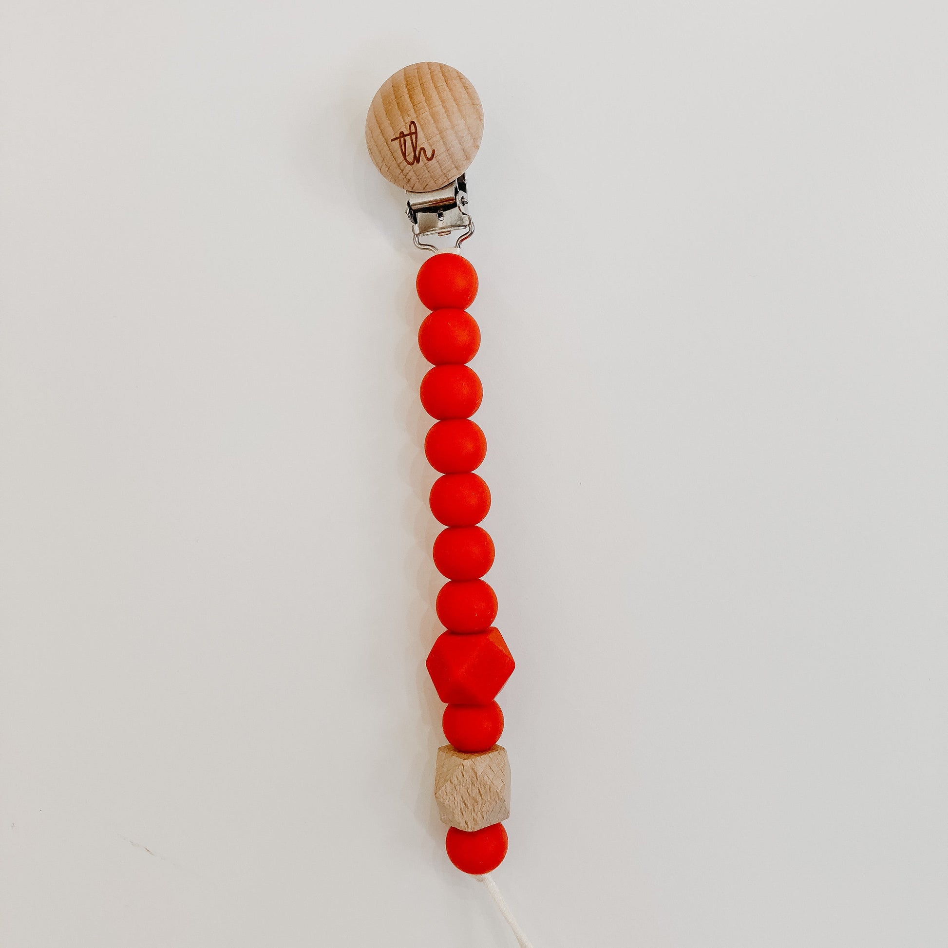 the jolie pacifier clip in scarlett red